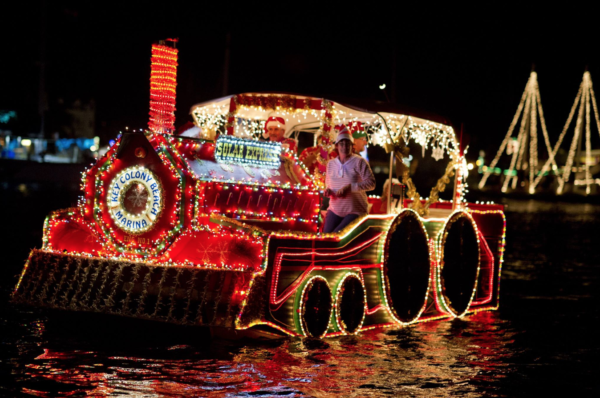 Holiday Boat Parade Image. Boat is covered in holiday lights that resemble a train.