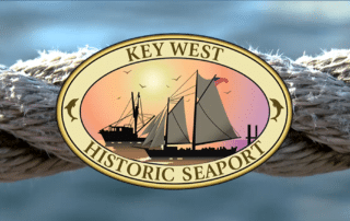key west historic seaport logo with rope around it and a blueish background.
